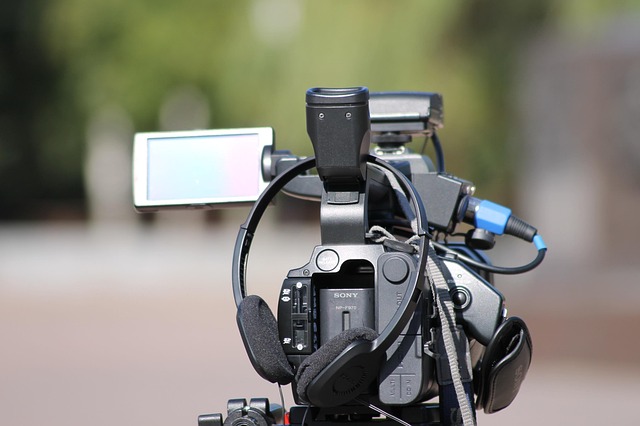 camera operator filming interview desk